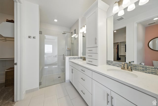 6034 W Sparrow View Dr, South Jordan, UT 84009 - bathroom featuring a stall shower, a walk in closet, double vanity, tile patterned floors, and toilet