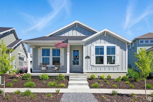 6034 W Sparrow View Dr, South Jordan, UT 84009 - view of front of house with covered porch, board and batten siding, and roof with shingles