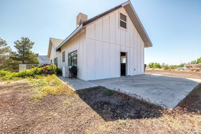 740 W Uzona Ave, Hildale, UT 84784 - back of property with board and batten siding, a patio, and a chimney