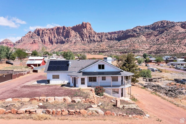 740 W Uzona Ave, Hildale, UT 84784 - view of front facade featuring solar panels and a mountain view