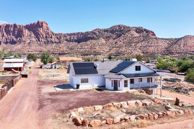 740 W Uzona Ave, Hildale, UT 84784 - view of front of property featuring covered porch, roof mounted solar panels, and a mountain view