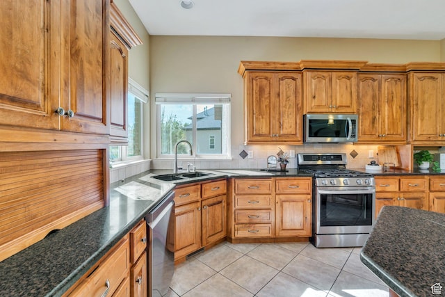 2632 S 2975 W, West Haven, UT 84401 - kitchen with appliances with stainless steel finishes, a sink, decorative backsplash, light tile patterned floors, and dark stone countertops