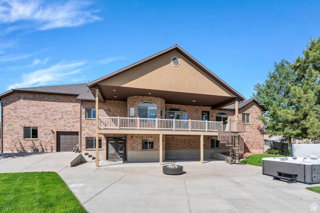 2632 S 2975 W, West Haven, UT 84401 - back of property with a hot tub, a patio area, stairway, brick siding, and a fire pit