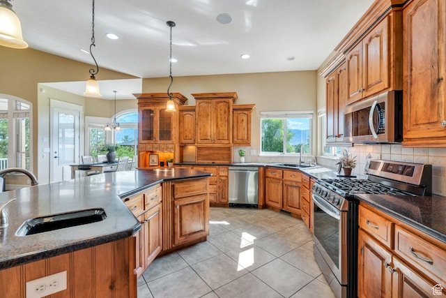 2632 S 2975 W, West Haven, UT 84401 - kitchen with appliances with stainless steel finishes, a sink, backsplash, brown cabinets, and recessed lighting