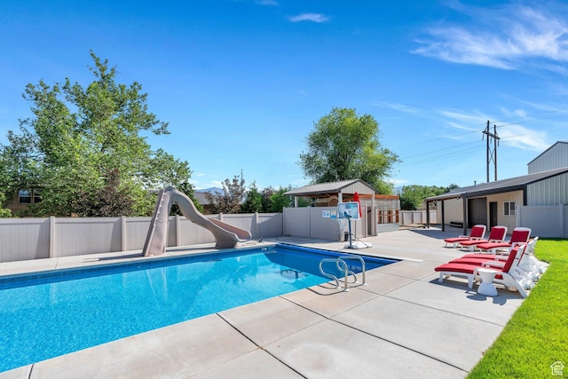 2632 S 2975 W, West Haven, UT 84401 - view of pool with a patio area, a water slide, and a fenced backyard