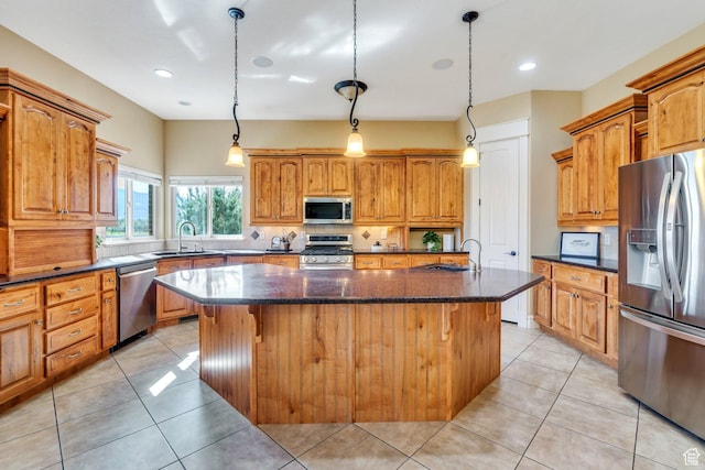 2632 S 2975 W, West Haven, UT 84401 - kitchen with appliances with stainless steel finishes, a sink, a kitchen island with sink, dark stone countertops, and recessed lighting