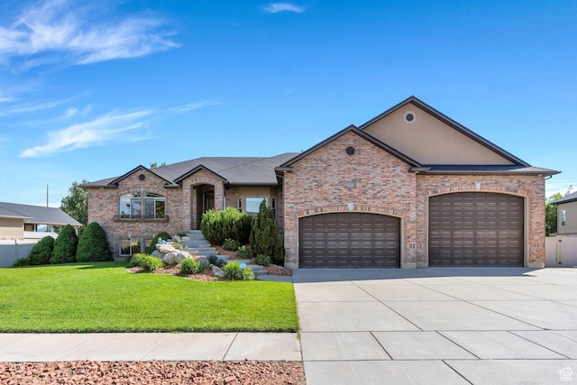 2632 S 2975 W, West Haven, UT 84401 - french country inspired facade with concrete driveway, a front yard, an attached garage, and brick siding