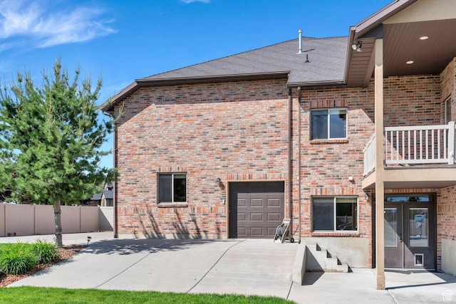 2632 S 2975 W, West Haven, UT 84401 - back of house featuring brick siding, a garage, concrete driveway, and roof with shingles