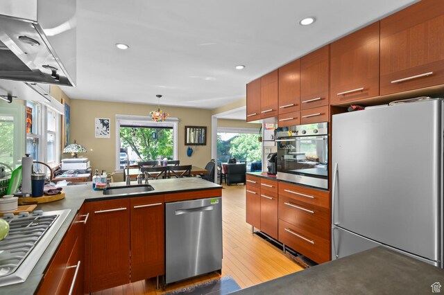 1451 E Redondo, Salt Lake City, UT 84105 - kitchen featuring appliances with stainless steel finishes, a sink, ventilation hood, a peninsula, and light wood-style floors