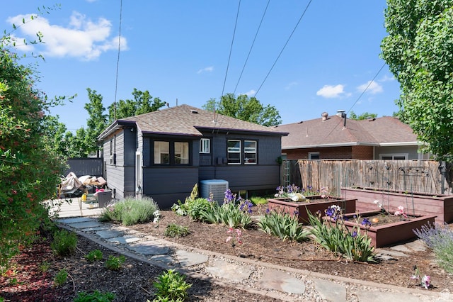 1451 E Redondo, Salt Lake City, UT 84105 - back of property featuring a garden, roof with shingles, and central air condition unit