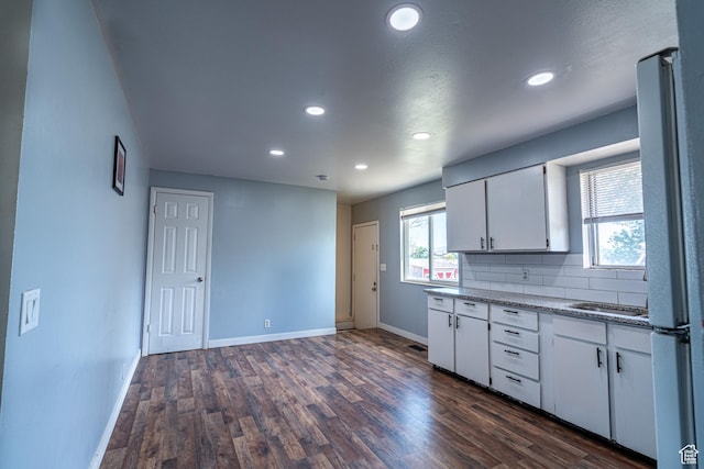 3309 S 8000 W, Magna, UT 84044 - kitchen featuring baseboards, white cabinets, dark wood-style floors, recessed lighting, and decorative backsplash