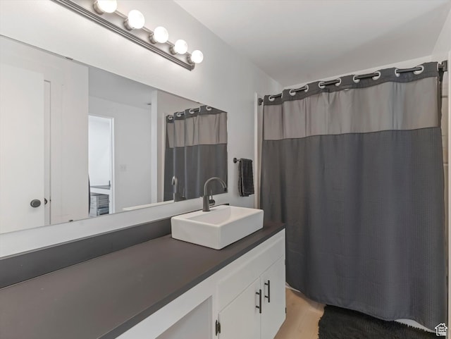 3951 S 875 E Unit 25, Ogden, UT 84403 - bathroom featuring vanity, wood finished floors, and a shower with curtain