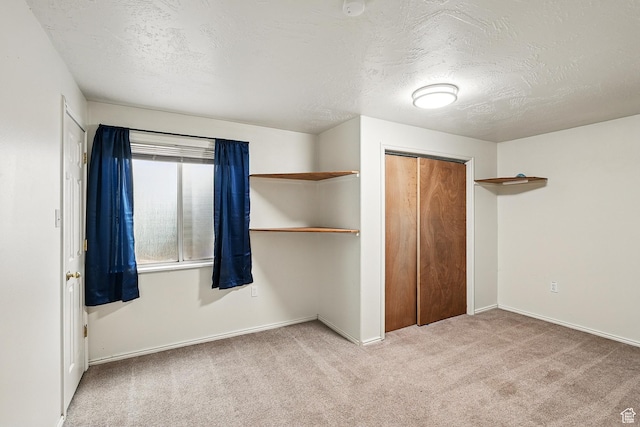 1790 E Homestead, Enoch, UT 84721 - unfurnished bedroom featuring carpet flooring, a closet, a textured ceiling, and baseboards