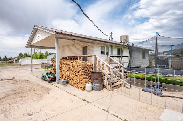 1790 E Homestead, Enoch, UT 84721 - view of side of property featuring a trampoline, stairway, and metal roof