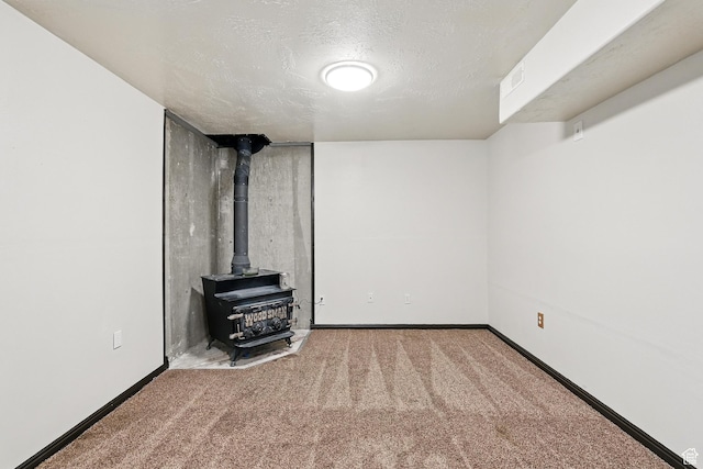 1790 E Homestead, Enoch, UT 84721 - finished below grade area with a wood stove, carpet floors, baseboards, and a textured ceiling