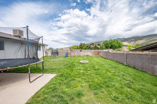 1790 E Homestead, Enoch, UT 84721 - view of yard with a trampoline, a playground, and a patio area