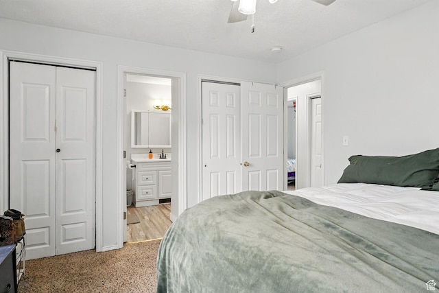 1790 E Homestead, Enoch, UT 84721 - bedroom featuring multiple closets, connected bathroom, and a ceiling fan