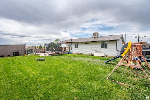 1790 E Homestead, Enoch, UT 84721 - back of house with a trampoline, metal roof, a playground, cooling unit, and a wooden deck