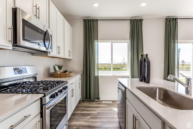 1803 E Bison Dr Unit B212, Eagle Mountain, UT 84005 - kitchen with stainless steel appliances, a sink, healthy amount of natural light, light wood-type flooring, and recessed lighting