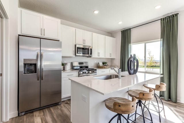 1803 E Bison Dr Unit B212, Eagle Mountain, UT 84005 - kitchen with stainless steel appliances, a sink, dark wood-style floors, white cabinetry, and recessed lighting