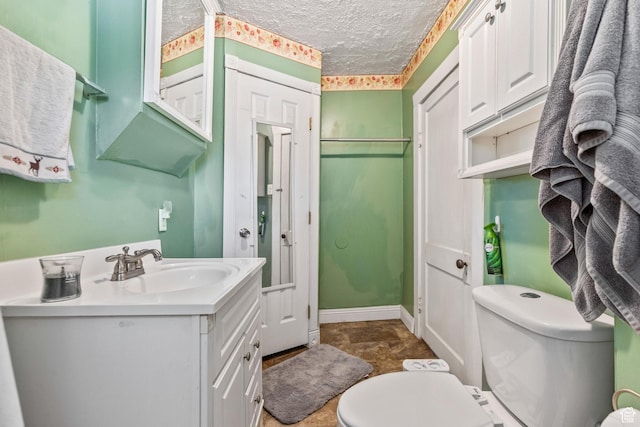 381 E 300 S, Logan, UT 84321 - bathroom with vanity, toilet, and a textured ceiling