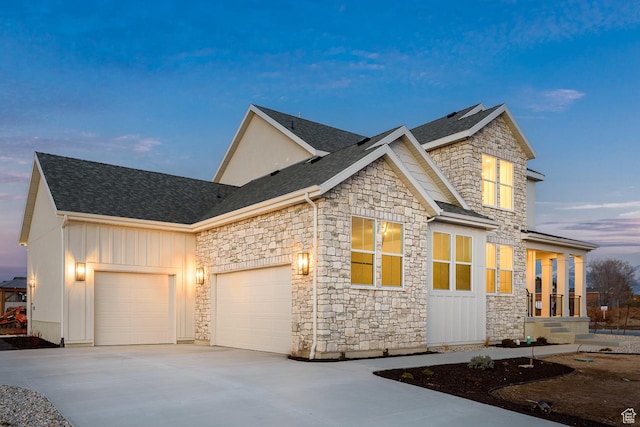 1116 W 2325 S, Syracuse, UT 84075 - craftsman-style house with stone siding, a garage, driveway, board and batten siding, and roof with shingles