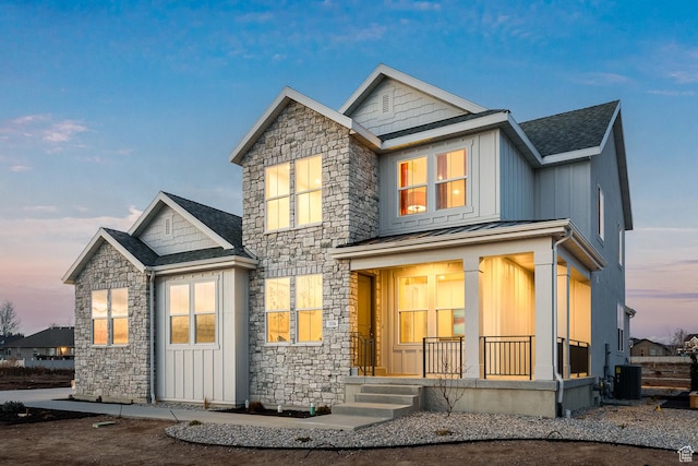 1116 W 2325 S, Syracuse, UT 84075 - view of front of property with covered porch, stone siding, a standing seam roof, metal roof, and cooling unit