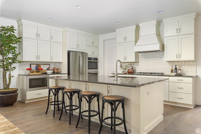 1116 W 2325 S, Syracuse, UT 84075 - kitchen with a sink, premium range hood, stainless steel appliances, dark countertops, and wood finished floors