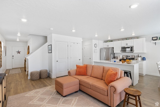 3547 E 1360 S, Spanish Fork, UT 84660 - living area with light wood finished floors, baseboards, recessed lighting, and stairs