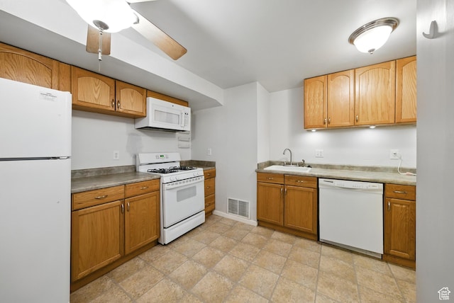 9604 S Stornoway Cir W, South Jordan, UT 84009 - kitchen with white appliances, a sink, ceiling fan, brown cabinetry, and baseboards