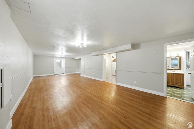 9604 S Stornoway Cir W, South Jordan, UT 84009 - unfurnished living room with light wood finished floors and baseboards