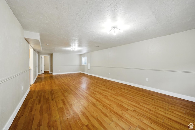 9604 S Stornoway Cir W, South Jordan, UT 84009 - empty room featuring a textured ceiling, hardwood / wood-style flooring, and baseboards