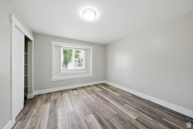 9604 S Stornoway Cir W, South Jordan, UT 84009 - unfurnished bedroom featuring wood finished floors, baseboards, and a closet
