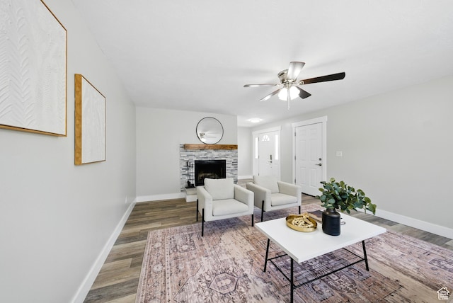 9604 S Stornoway Cir W, South Jordan, UT 84009 - living room featuring ceiling fan, wood finished floors, baseboards, and a stone fireplace