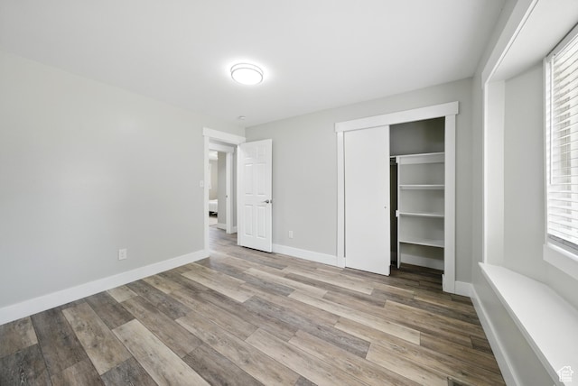 9604 S Stornoway Cir W, South Jordan, UT 84009 - unfurnished bedroom featuring wood finished floors, a closet, and baseboards