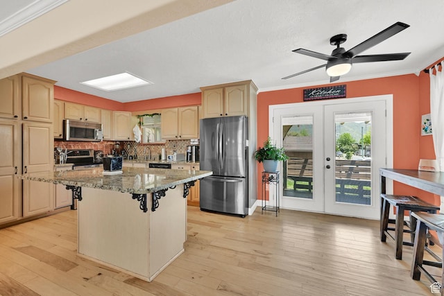1368 E 5800 S, South Ogden, UT 84405 - kitchen featuring appliances with stainless steel finishes, ornamental molding, a ceiling fan, tasteful backsplash, and light stone countertops