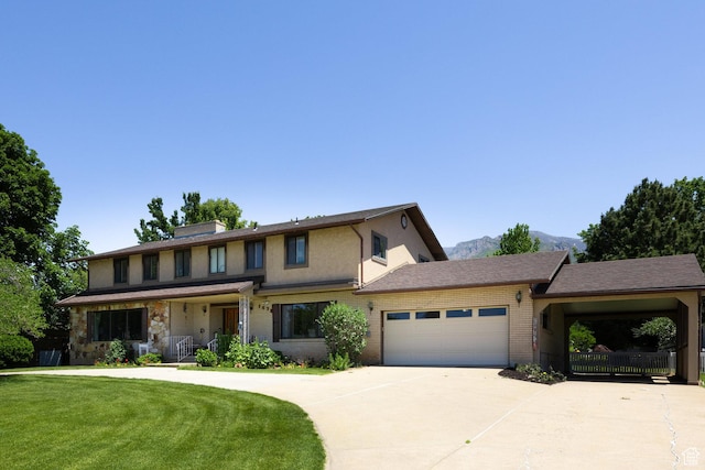1478 N Ewe Turn St E, Kaysville, UT 84037 - view of front of property with brick siding, a front yard, an attached garage, concrete driveway, and covered porch