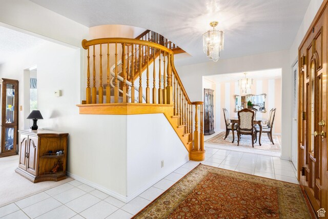 1478 N Ewe Turn St E, Kaysville, UT 84037 - tiled foyer entrance featuring a chandelier, stairs, and baseboards