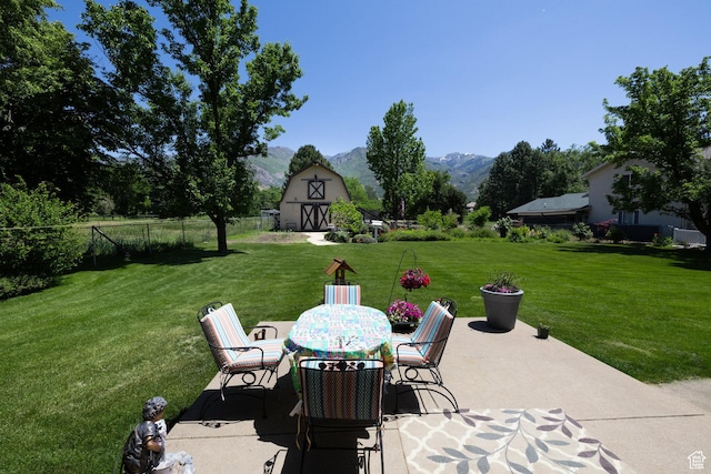 1478 N Ewe Turn St E, Kaysville, UT 84037 - view of patio featuring a barn, a mountain view, an outbuilding, and outdoor dining area