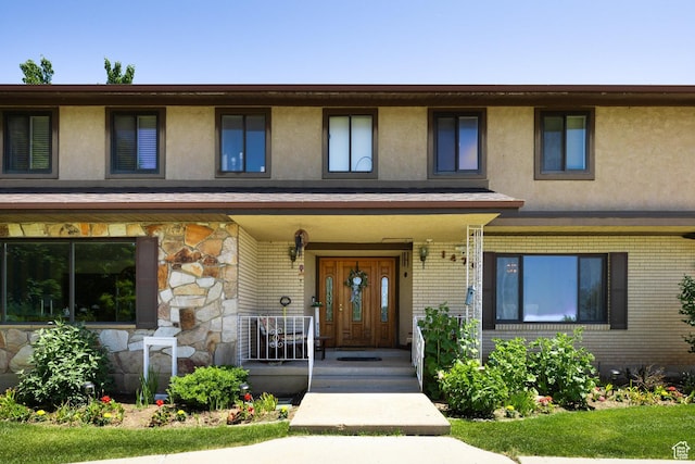1478 N Ewe Turn St E, Kaysville, UT 84037 - view of front of house with stucco siding, brick siding, covered porch, and stone siding