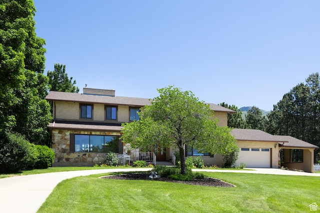 1478 N Ewe Turn St E, Kaysville, UT 84037 - view of front of house featuring a front lawn, a garage, concrete driveway, and stone siding