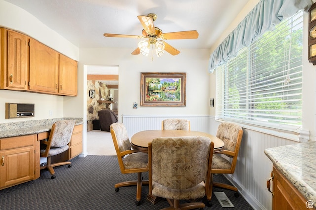 1478 N Ewe Turn St E, Kaysville, UT 84037 - dining area featuring dark colored carpet, wainscoting, and a ceiling fan