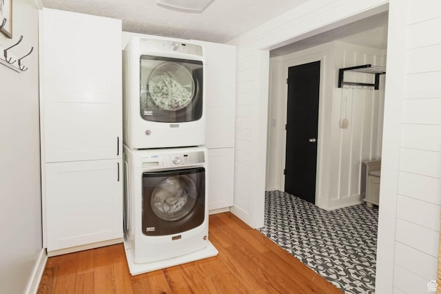 5363 E Cub Rd, Preston, ID 83263 - washroom with estacked washer and dryer, light wood finished floors, and baseboards
