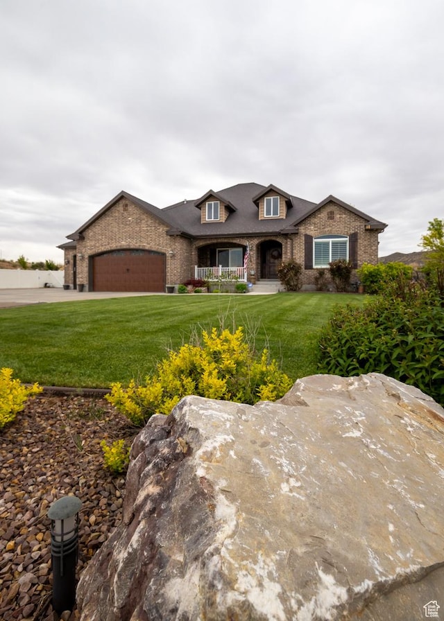 403 W 4000 S, Vernal, UT 84078 - view of front of property with a garage, a front yard, covered porch, and brick siding