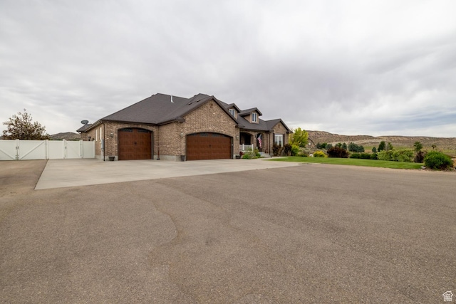 403 W 4000 S, Vernal, UT 84078 - french country inspired facade featuring a gate, an attached garage, brick siding, and asphalt driveway