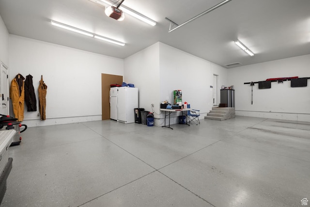 403 W 4000 S, Vernal, UT 84078 - garage featuring a garage door opener and freestanding refrigerator