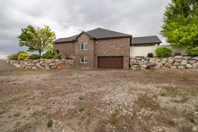 403 W 4000 S, Vernal, UT 84078 - view of home's exterior featuring brick siding, a garage, and dirt driveway