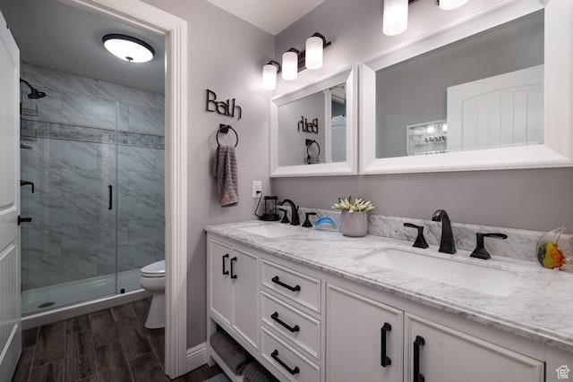 403 W 4000 S, Vernal, UT 84078 - bathroom featuring double vanity, a stall shower, toilet, and wood finish floors