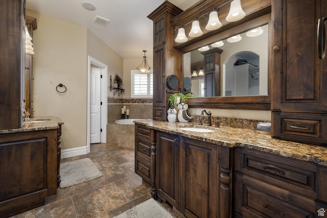 403 W 4000 S, Vernal, UT 84078 - full bath with stone tile floors, two vanities, a bath, and baseboards