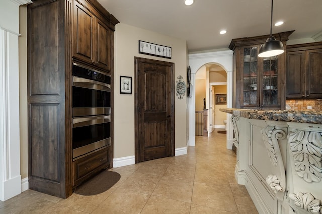 403 W 4000 S, Vernal, UT 84078 - kitchen featuring double oven, arched walkways, dark brown cabinetry, glass insert cabinets, and recessed lighting